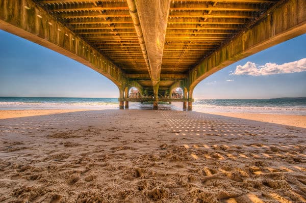 pier with ambient light turning sand blue